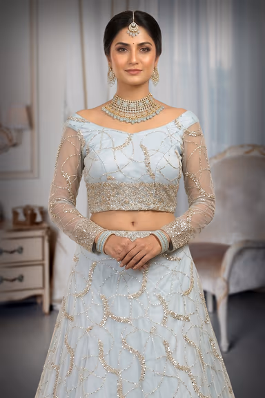 Elegant Light Blue Lehenga Featuring Intricate Silver Embroidery Sheer Full Sleeves And A Graceful Flowing… — view 1 of 3