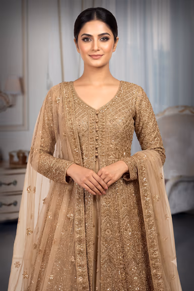 An Exquisite Floor Length Gown In Golden Featuring All Over Intricate Hand Embroidery Mirror Work And A… — view 1 of 2