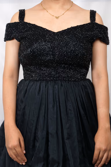 Exquisite Black Evening Gown Featuring A Shimmering Embellished Bodice And A Voluminous Flowing Skirt For A… — view 3 of 5