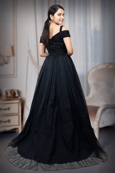 Exquisite Black Evening Gown Featuring A Shimmering Embellished Bodice And A Voluminous Flowing Skirt For A… — view 5 of 5
