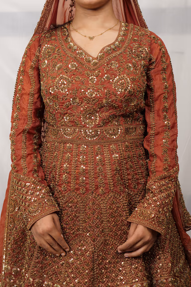 Regal Rust Colored Sharara Suit Adorned With Intricate Gold Zardosi Embroidery And Traditional Patterns — view 6 of 6