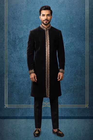 Experience Royal Grace In This Deep Black Velvet Sherwani Showcasing Exquisite Gold Embroidery Along The… — view 1 of 3