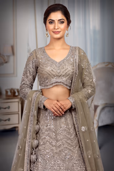 Beige Heavy Worked Lehenga With Rich Embellishment Work In Skirt And Top Along With Minimal Net Dupatta — view 1 of 3