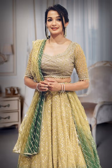 Metallic Green Heavy Embellished Bridal Lehenga With Golden Stone Details On Skirt , Crop Top And Dupatta — view 1 of 2