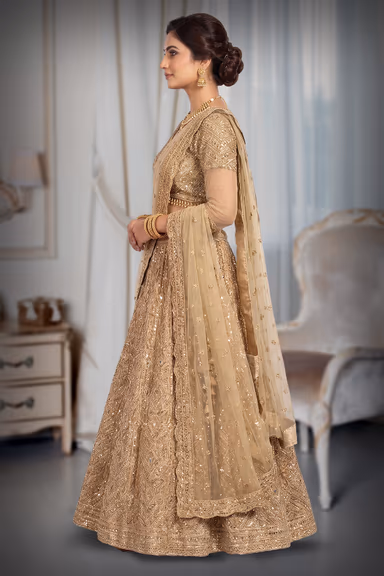 A Radiant Gold Lehenga With Detailed Mirrorwork And Zari, Paired With A Soft Net Dupatta For An Elegant Finish. — view 4 of 6