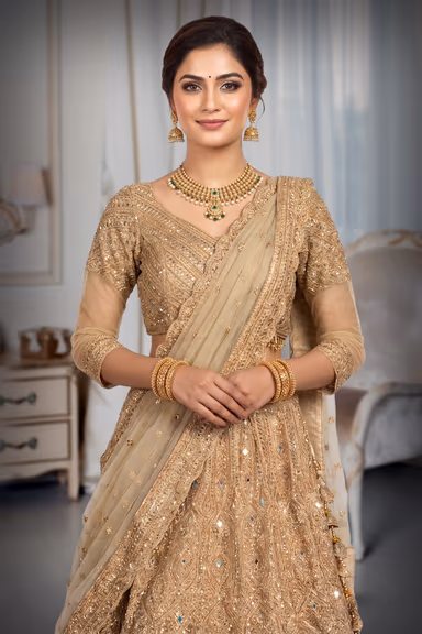 A Radiant Gold Lehenga With Detailed Mirrorwork And Zari, Paired With A Soft Net Dupatta For An Elegant Finish. — view 5 of 6