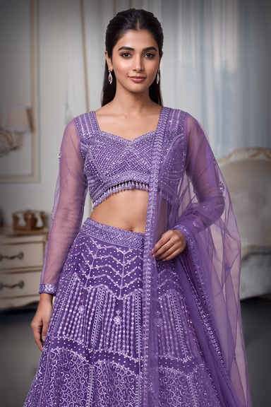 Regal Purple Net Lehenga With Stone Work Details And Raindrop Beads Detailing In Waist Line With Same Color… — view 1 of 4