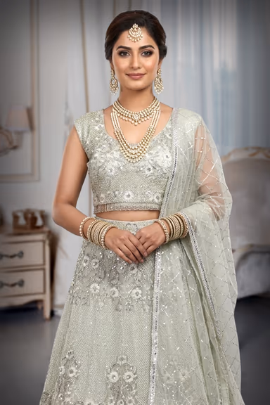 Sage Green Crop Top Lehenga With Heavy Detailed Skirt With Floral Designs And Sleeveless Blouse — view 1 of 3