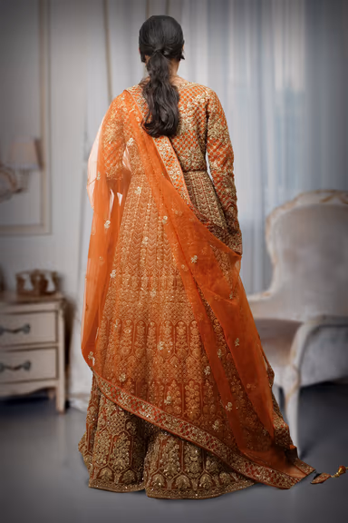 Radiant Gold Patterns Beautifully Contrast Against The Elegant Dark Orange Fabric Of This Lehenga — view 4 of 4