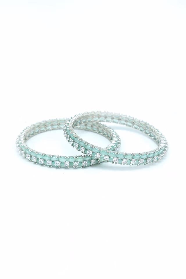 Captivating Silver Finished Bangles Adorned With Vibrant Green Stones Perfect For Adding Luxury To Any… — rent in Calicut