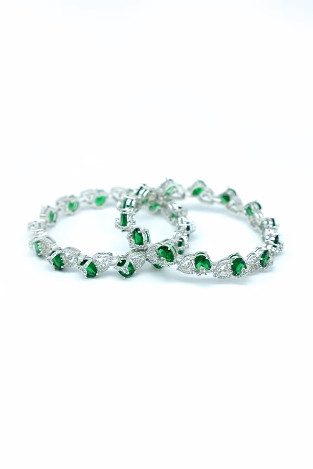 Stunning Handcrafted Bangles Feature Brilliant Green Gemstones Nestled Inside Ornate Circular White Stone… — rent in Calicut