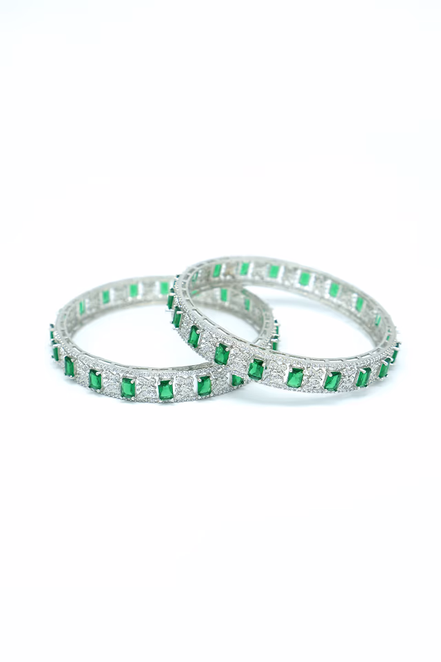 Radiant Silver Bangles Studded With Lush Green Oval Emeralds Providing A Bold And Luxurious Fashion… — rent in Calicut