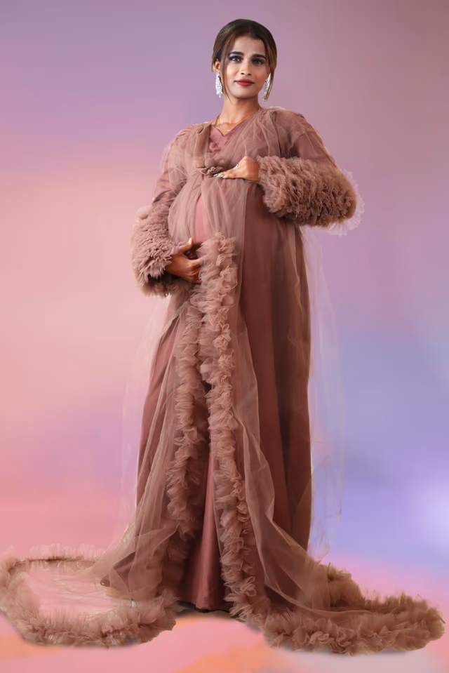 Pinkish brown ruffle sleeve robe open gown — back view, rent in Calicut