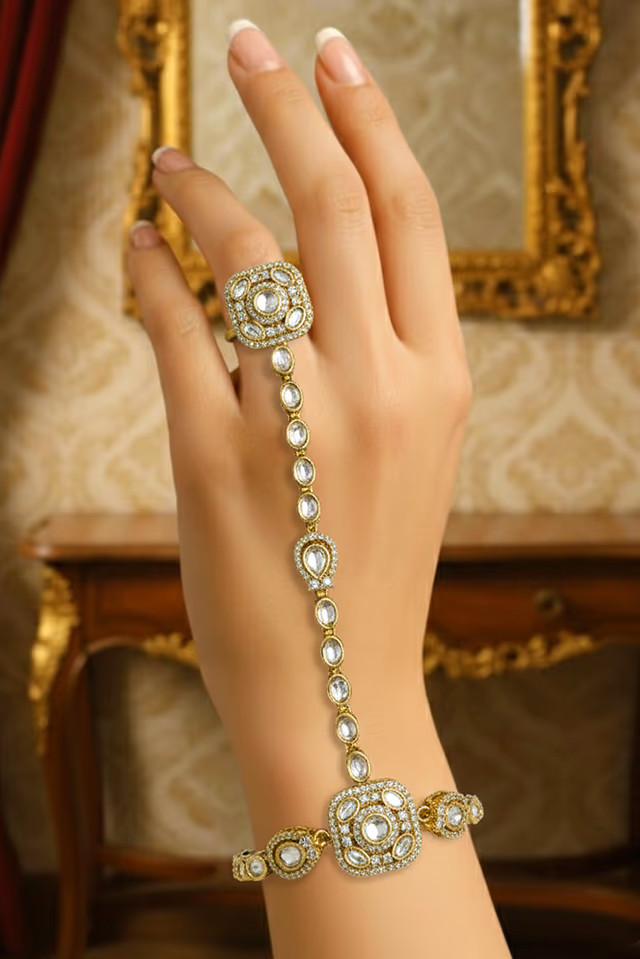 Elevate Your Ethnic Ensemble With This Stunning Gold Plated Hand Harness Adorned With Sparkling Stones — rent in Calicut