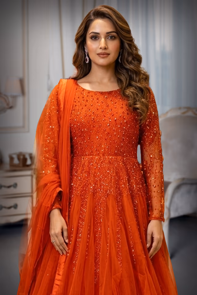 Graceful Dark Orange Gown Detailed With Delicate Floral Embroidery And Shimmering Accents — rent in Calicut