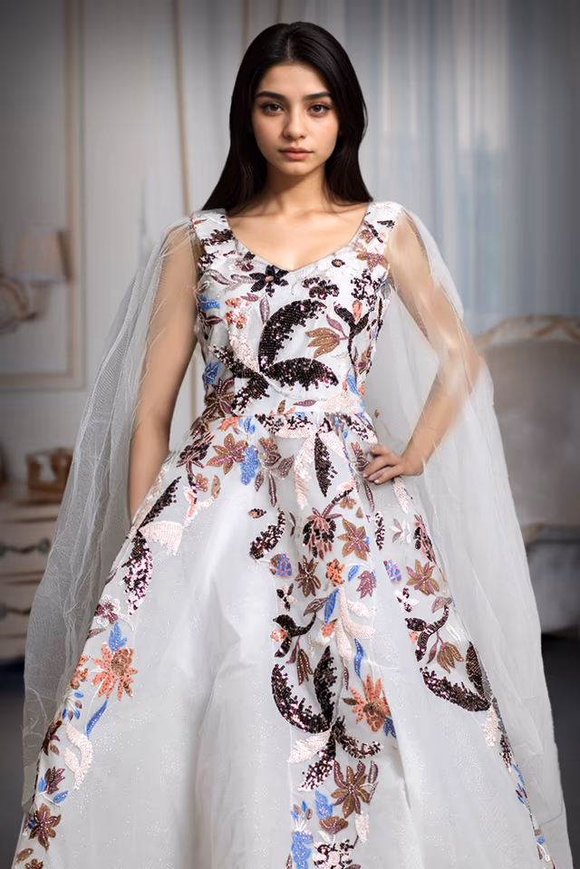 Ivory Crystal Garden Embroidered Net Gown – Multicolor Threadwork & Sequin Floral Design — rent in Coimbatore