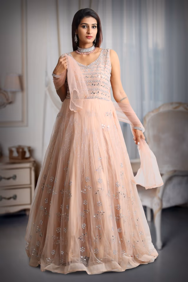 Pastel peach mirror work net gown with exquisite detailing on yoke and dupatta in same colour — back view, rent in Bangalore