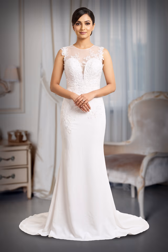 Pure White Lace Appliqué Illusion Sheer Neckline Fitted Bridal Gown with Subtle Train — back view, rent in Edappally