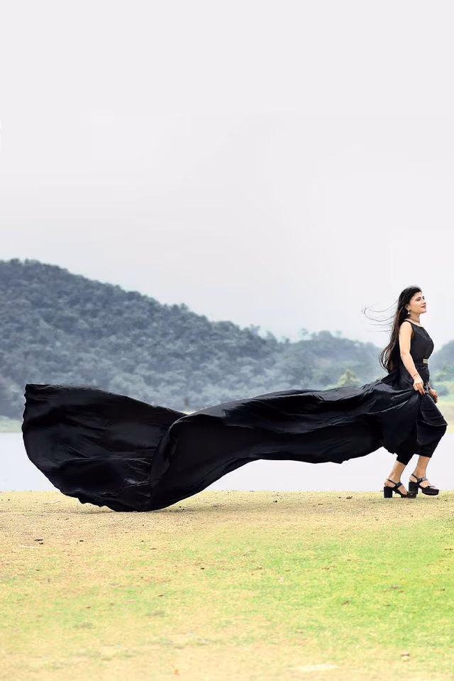 Black Satin Sleeveless Gown With Minimal Yoke And Flarey Back Tail — back view, rent in Bangalore