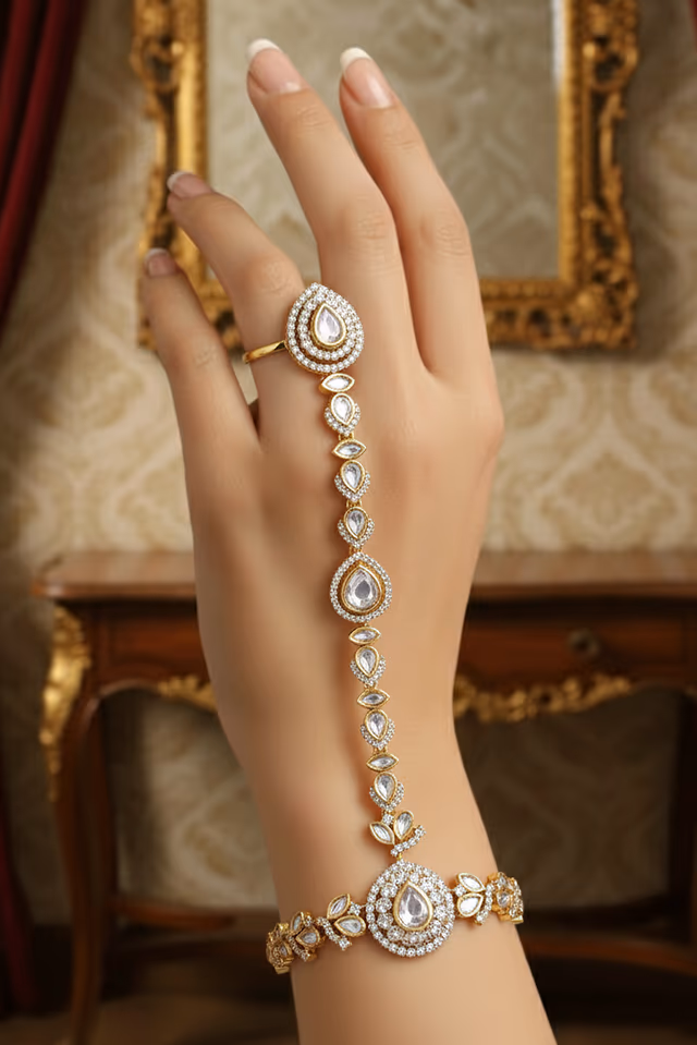 Traditional Gold Toned Haath Panja Features Intricate Floral Kundan Work For A Regal Appearance — rent in Calicut